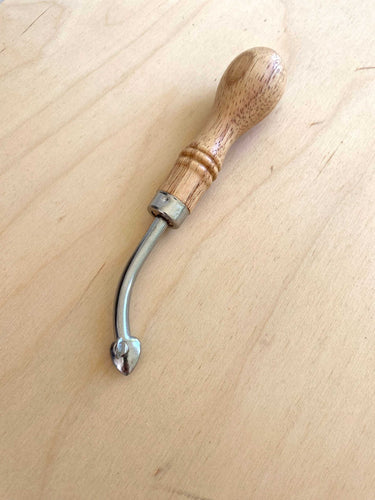 A leathercraft tool called an adjustable edge creaser