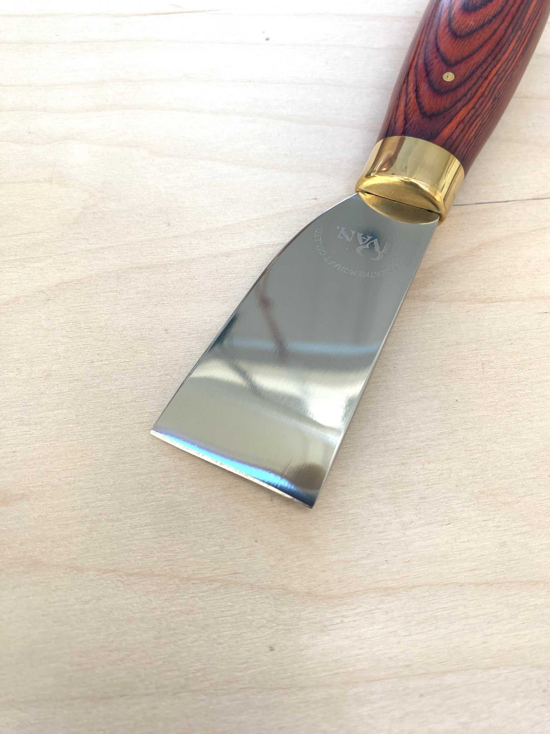 Stainless Steel Japanese Skiving Knife with ergonomic wood handle for leather craftsmen.