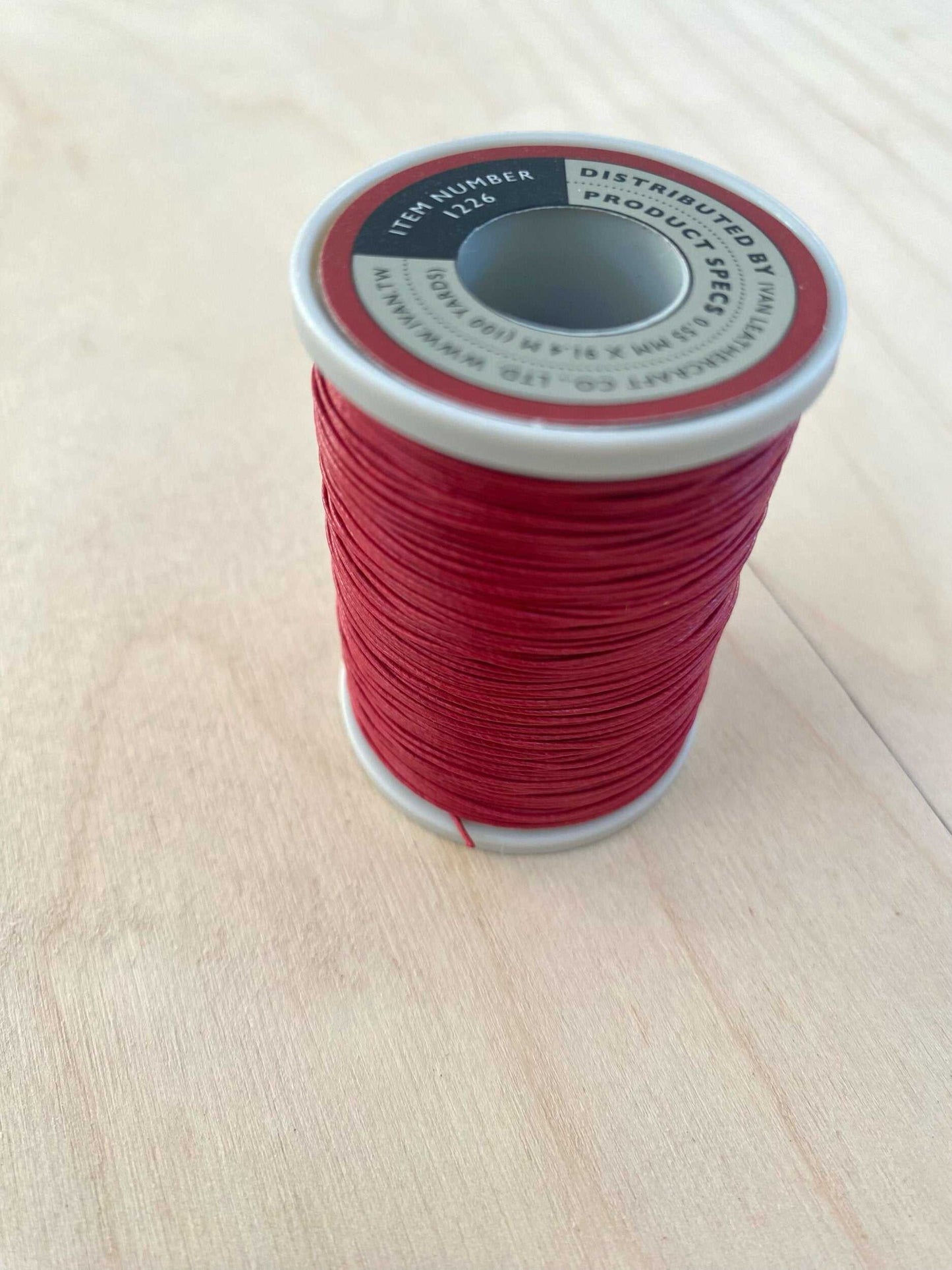 Red Cotton Linen Thread 0.55 mm spool for leatherworking, durable and vibrant red, 91.4 meters per spool.