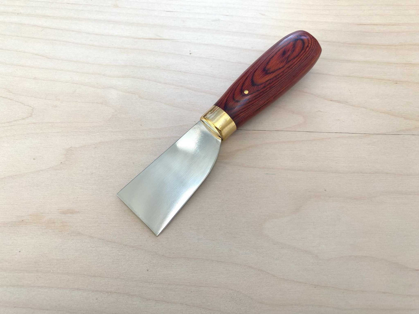 Stainless Steel Japanese Skiving Knife with a wooden handle for leather crafting.