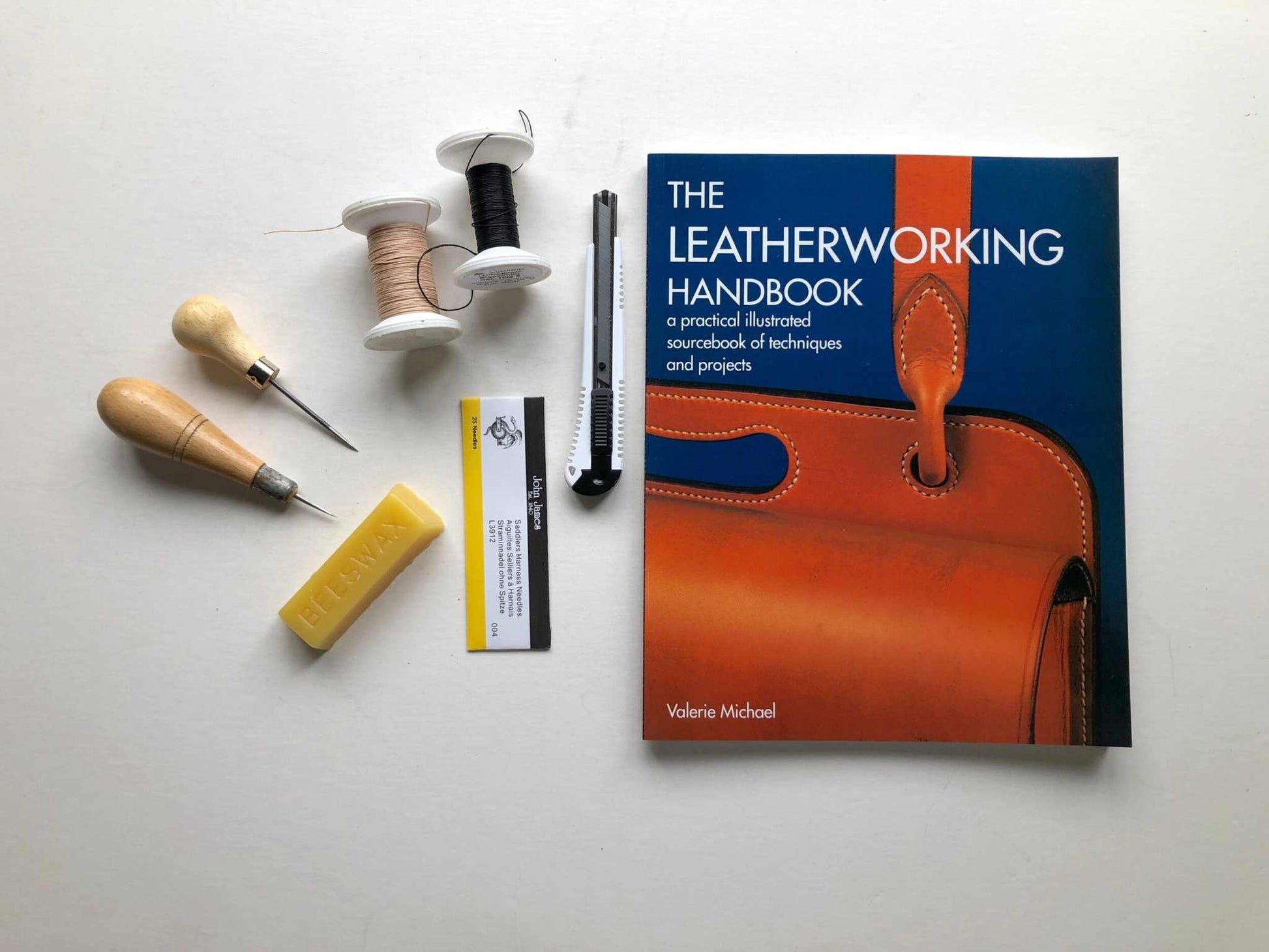 Leatherwork Starter Kit with tools, thread, beeswax, and leatherworking handbook by Valerie Michael.