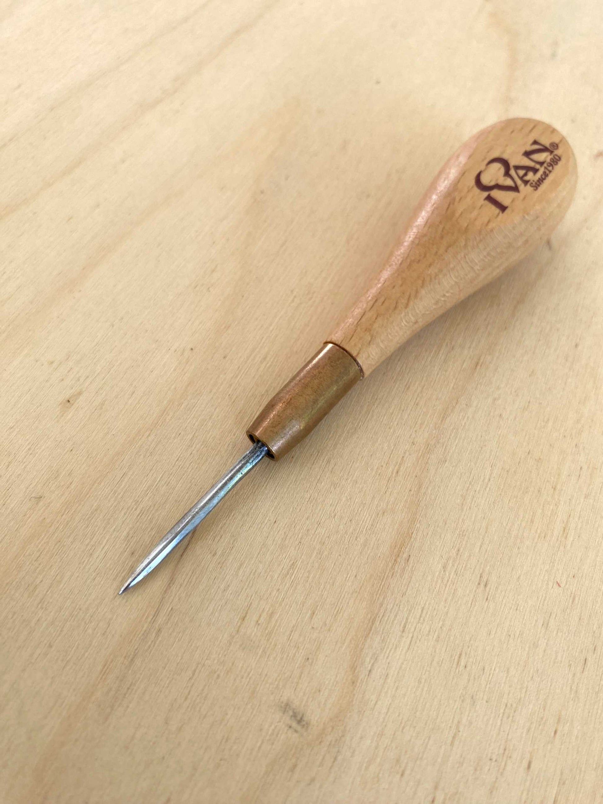 Straight Blade Leather Stitching Awl with Small Handle on Wooden Surface