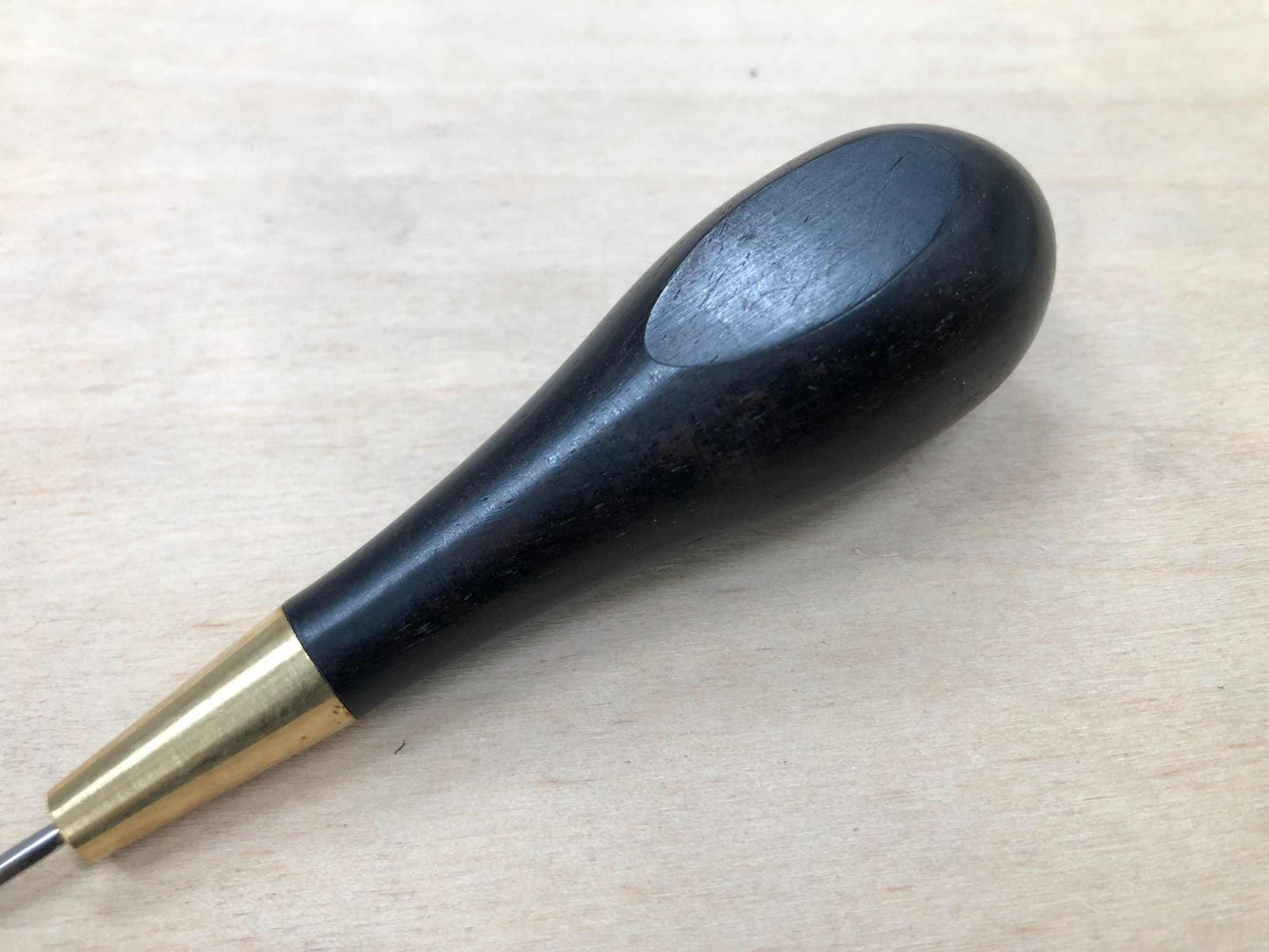 Wooden handled stitching awl with black ebony finish.