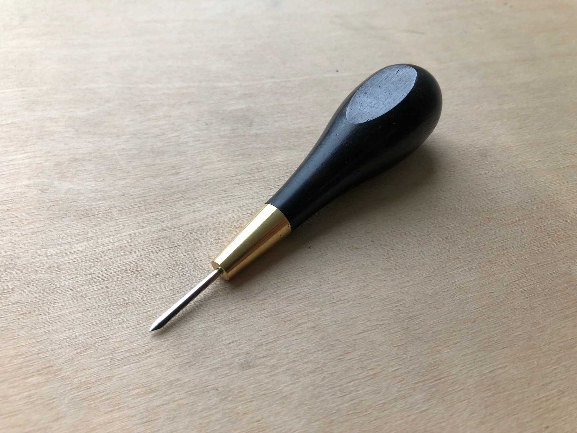 Wooden Handled Stitching Awl in black ebony with ergonomic design.