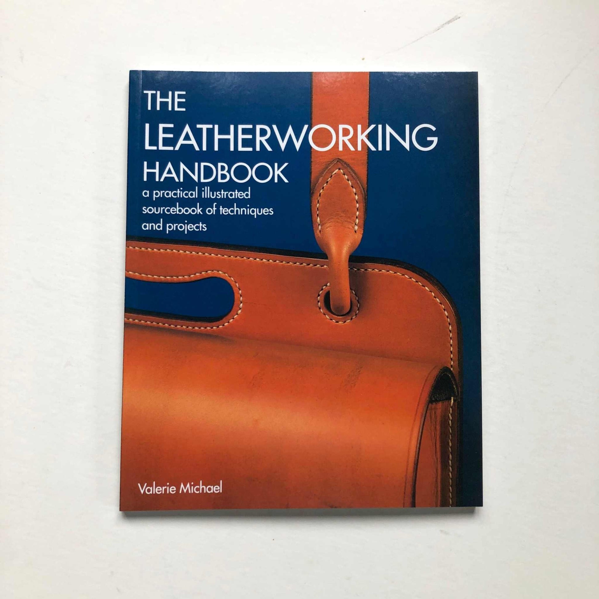 The Leatherworking Handbook cover image featuring leathercraft techniques and projects.