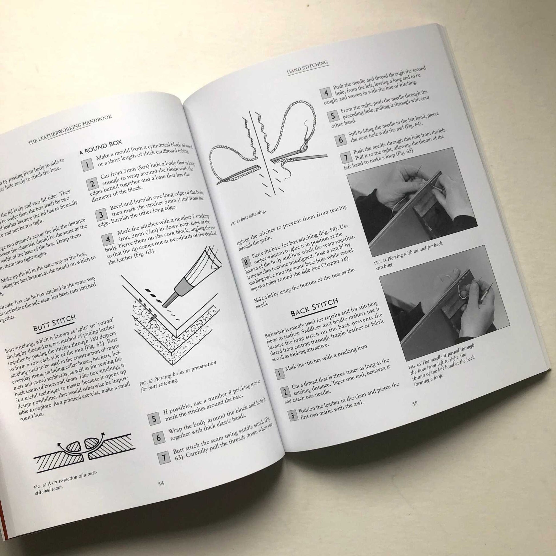 Open pages of 'The Leatherworking Handbook' showing leatherworking techniques and illustrations.