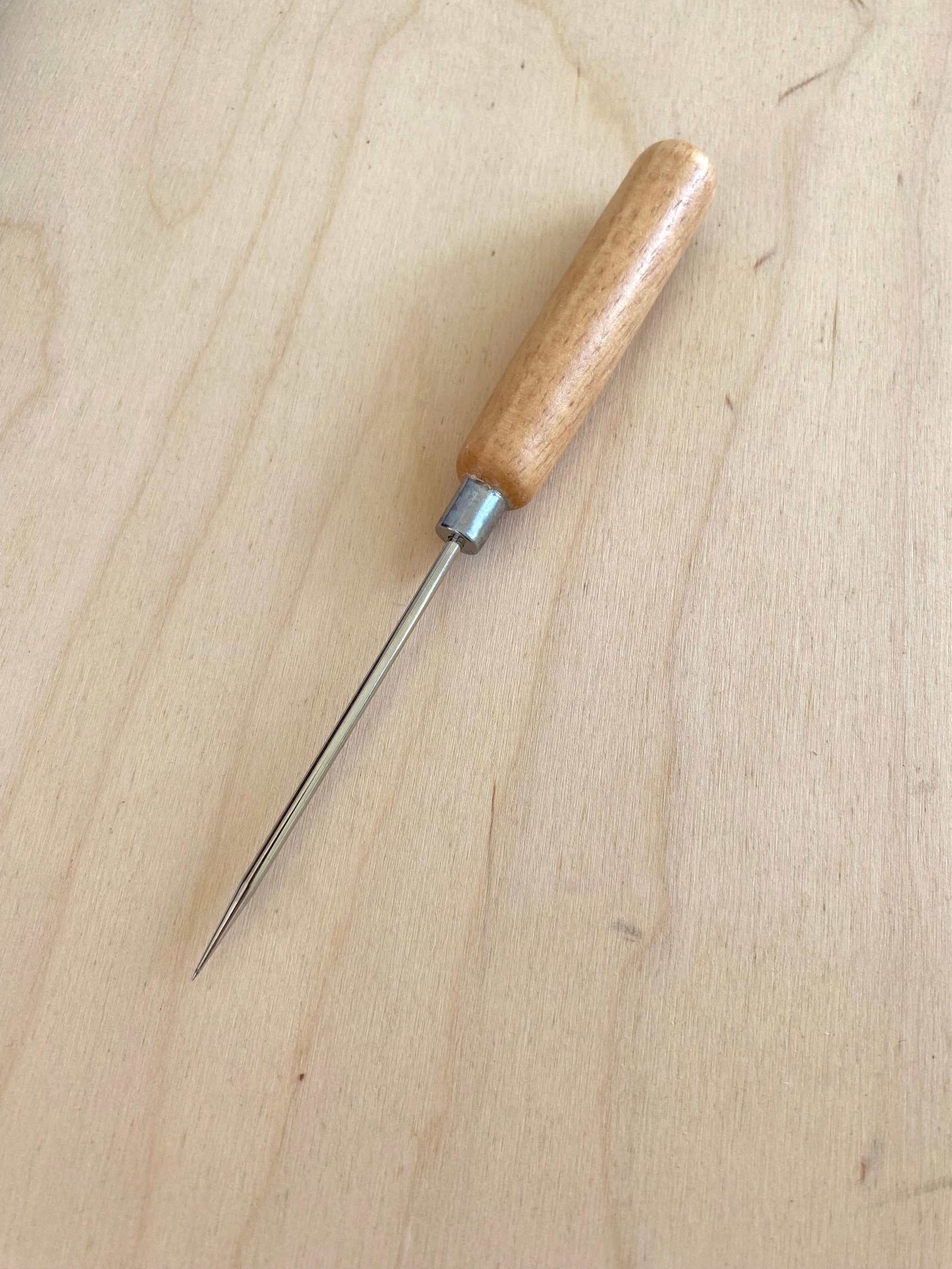 Long Handle Scratch Awl on light wooden surface.