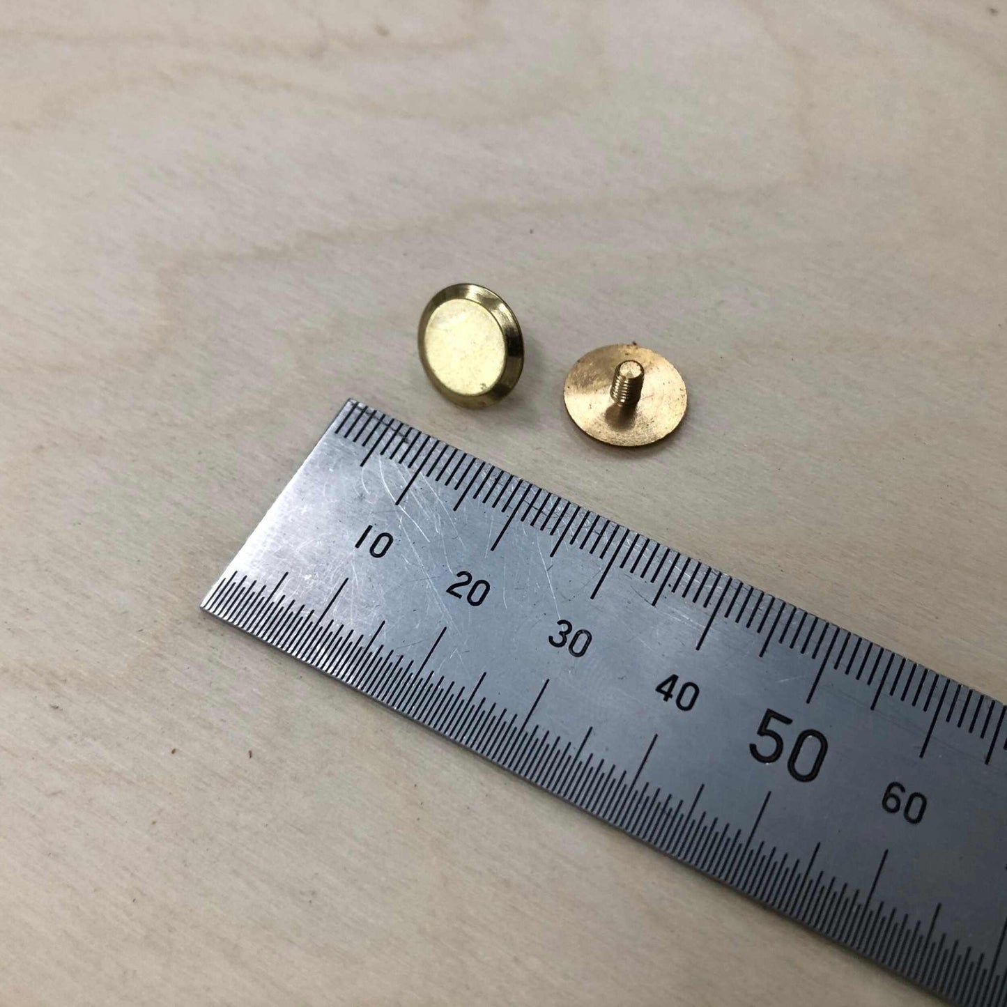 Chicago Screws in solid brass with ruler for size reference.