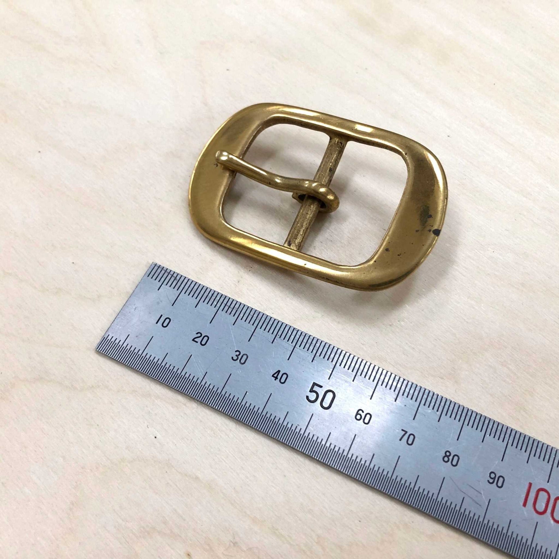 Solid brass belt buckle with double frame and pin, ideal for leather crafting.