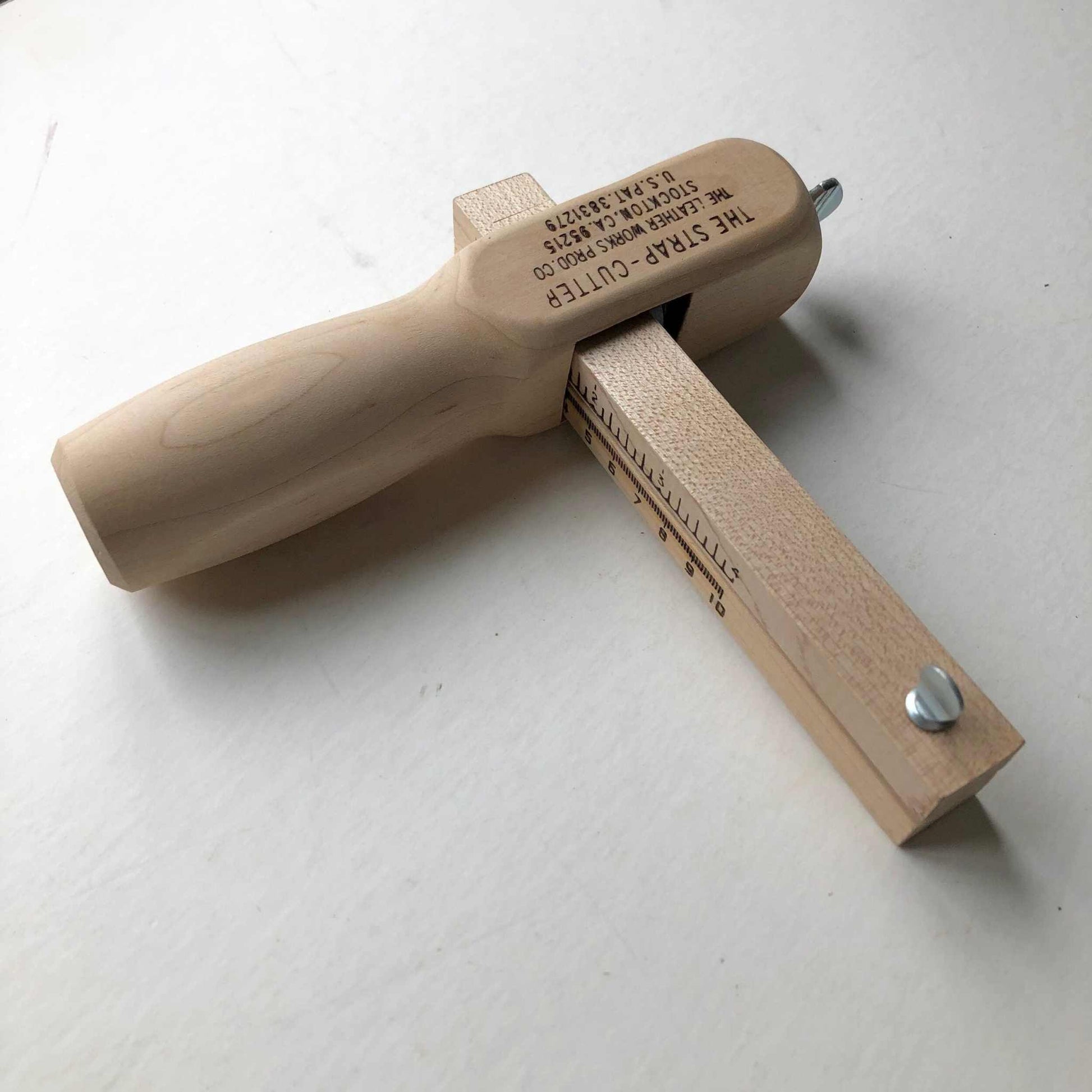 Wooden leather strap cutter with internal blade, made in the USA.